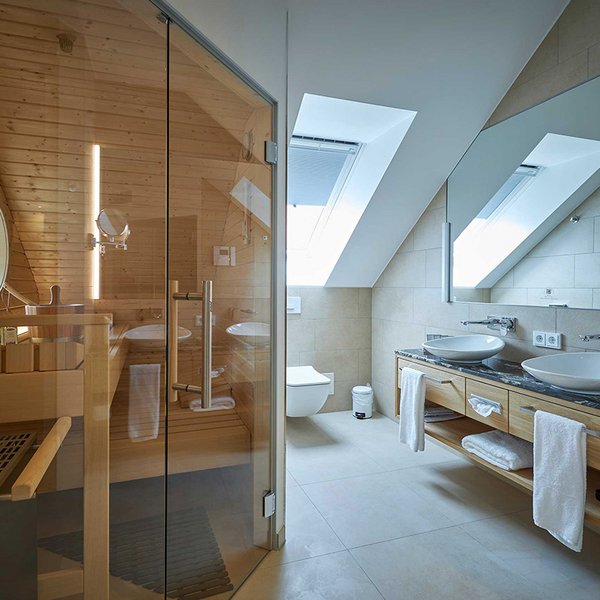 Foto des Badezimmers. Zu sehen sind zwei Waschbecken und die Sauna